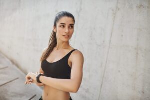Woman prepares to go for a jog, enjoying her more active lifestyle after downsizing her breasts with cosmetic breast surgery. Woman prepares to go for a jog, enjoying her more active lifestyle after downsizing her breasts with cosmetic breast surgery.