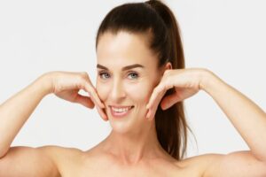 Middle aged woman has full cheeks after facial fat grafting restores volume