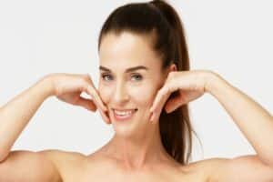 Middle aged woman has full cheeks after facial fat grafting restores volume