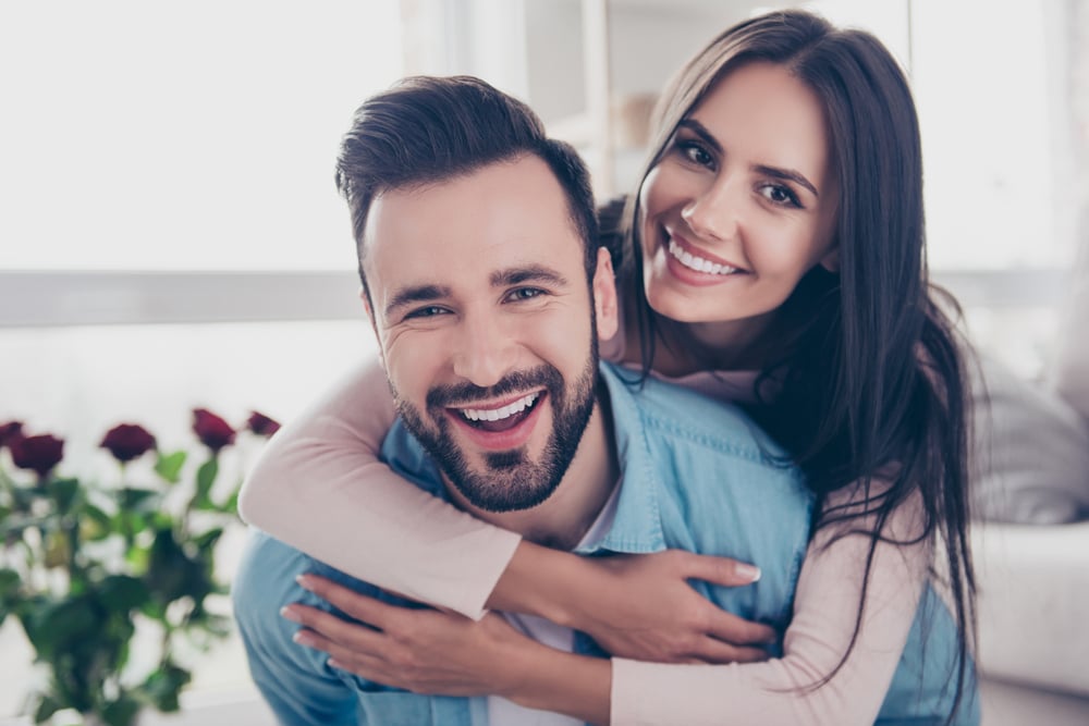 Couple with strong jawlines enjoys each other's company at home.