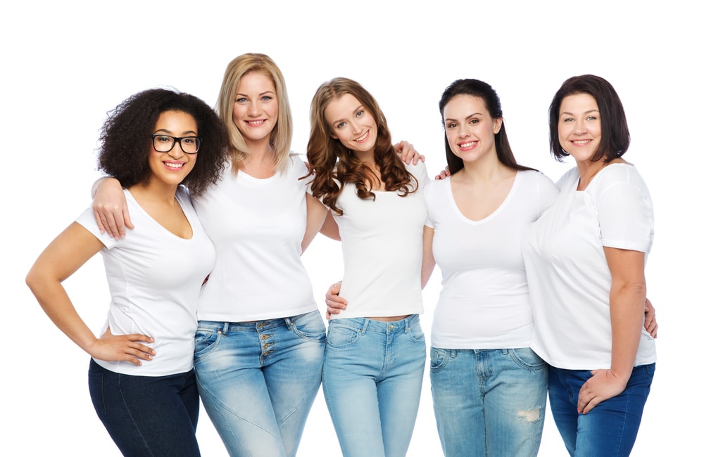 Diverse women of different body sizes pose for a photo together.